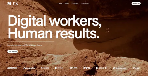 11x hero section: oversized white headline over a full-bleed rocky desert photo with a customer logo strip along the bottom