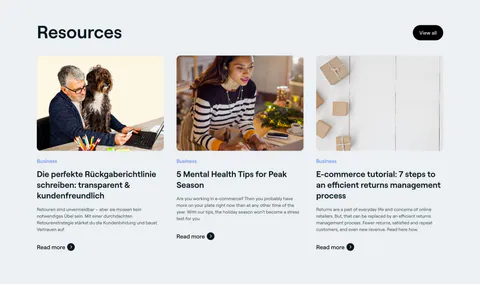 8returns blog & resources section: left headline with View all button above three article cards with photos on light gray
