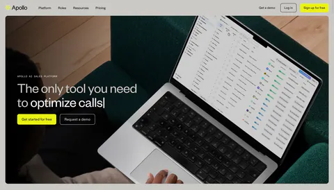 Apollo hero section: nav bar above a headline and two buttons overlaid on a full-bleed photo of a laptop showing a sales app