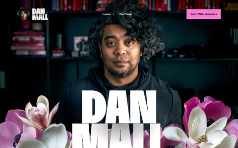 Dan Mall hero section: huge name over a full-bleed portrait photo with magnolia flowers and a serif tagline