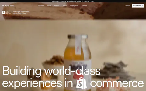 Hyper Effekt hero section: oversized white headline with an inline Shopify icon over a full-bleed blurred product photo, with nav
