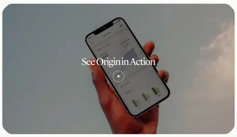 Origin how it works section: serif title and play button over a full-width photo of a hand holding a phone with the app against the sky
