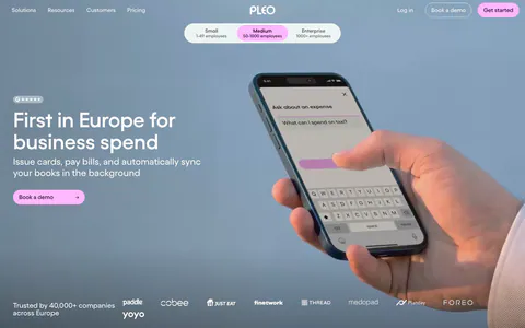 Pleo hero section: left-aligned headline and pink button over a full-bleed photo of a hand holding a phone, logo strip below