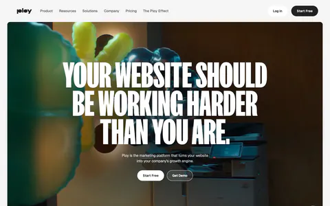 Ploy hero section: centered condensed uppercase headline and two buttons over a full-bleed office video frame with inflatable shapes