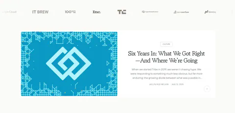 Tribe AI blog & resources section: press logo row above a featured article card with a blue geometric cover left and serif title right